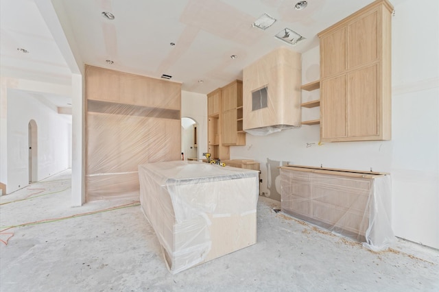 kitchen featuring light brown cabinetry and open shelves