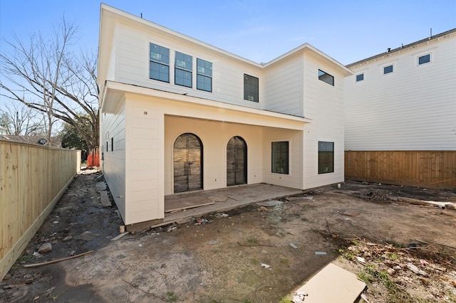 view of front of property with a patio area and a fenced backyard