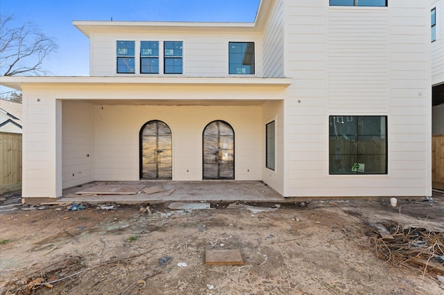 rear view of house featuring a patio area and fence