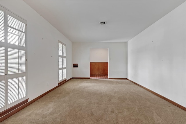 carpeted spare room with baseboards