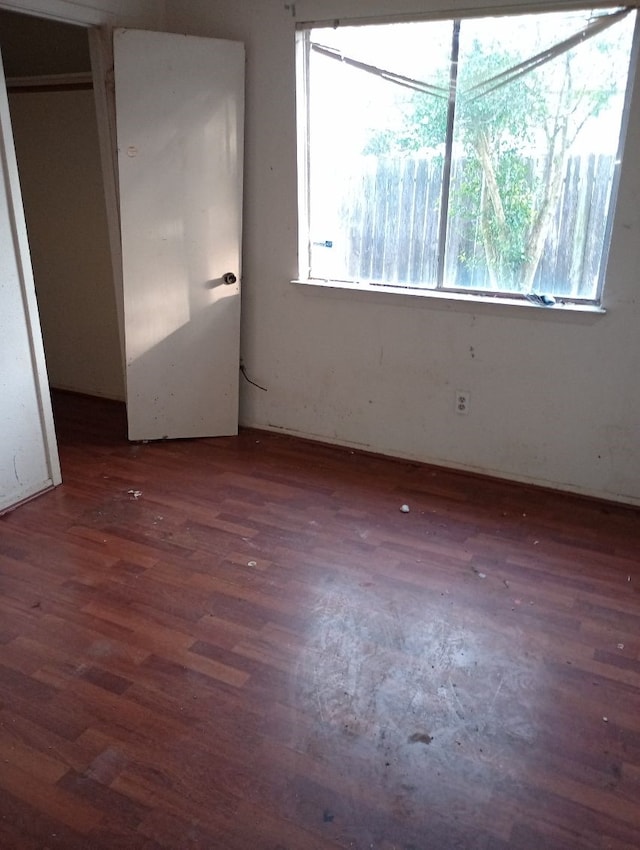 spare room featuring wood finished floors