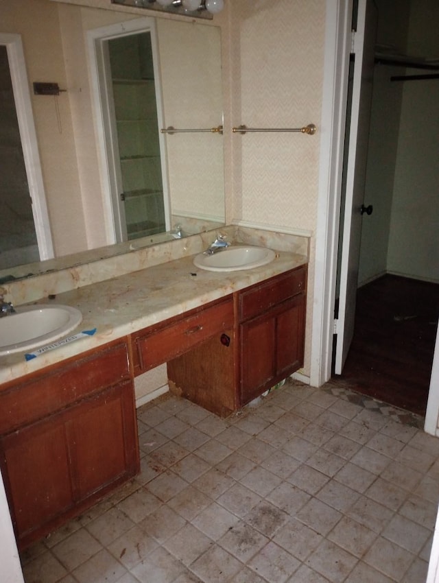 full bathroom featuring double vanity and a sink