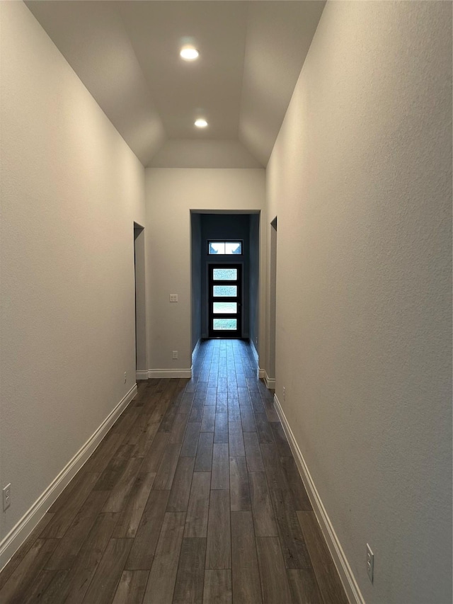 corridor featuring lofted ceiling, dark wood-type flooring, recessed lighting, and baseboards