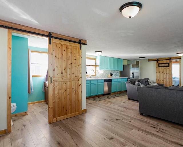 1821 County Road 201, Sargent, TX 77414 - living area with a barn door and light wood-style floors