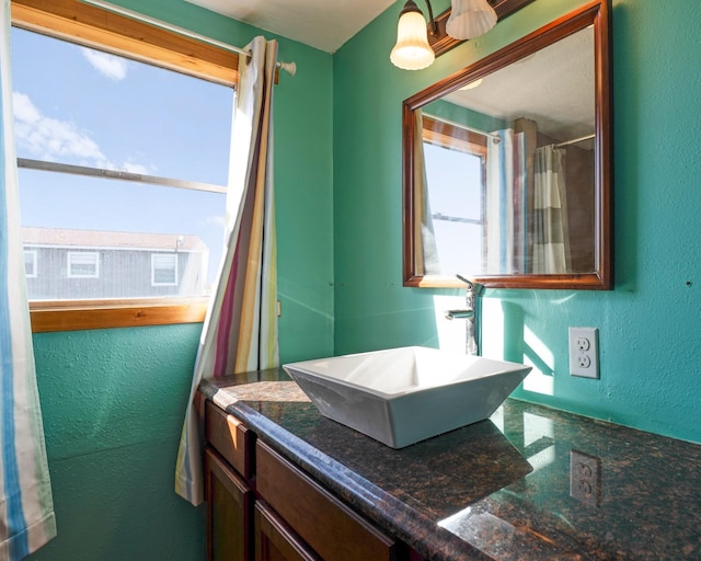 1821 County Road 201, Sargent, TX 77414 - full bathroom with a textured wall and vanity