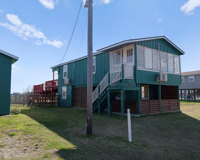 1821 County Road 201, Sargent, TX 77414 - back of property with board and batten siding and stairway