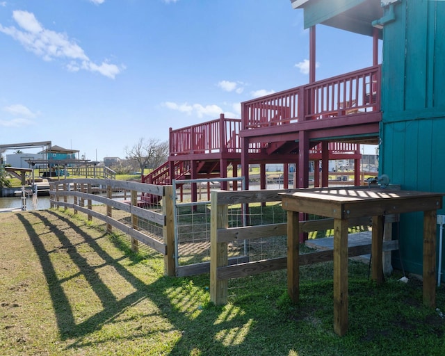 1821 County Road 201, Sargent, TX 77414 - view of playground featuring a lawn, a wooden deck, and stairway
