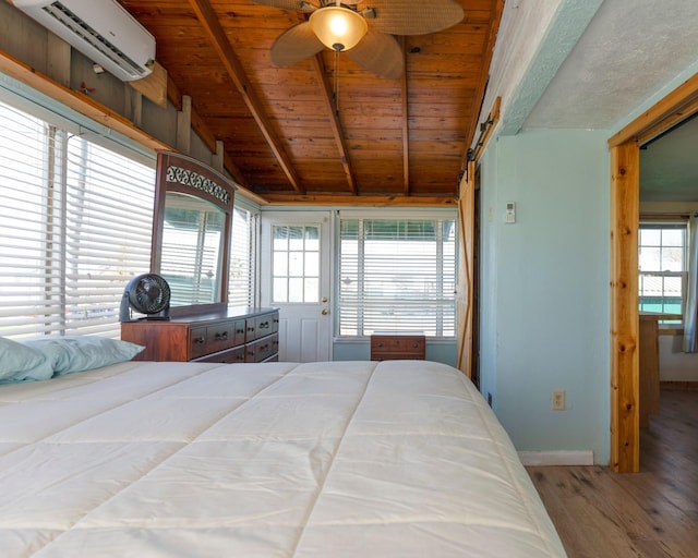 1821 County Road 201, Sargent, TX 77414 - bedroom featuring a wall mounted AC, wood finished floors, wooden ceiling, access to outside, and ceiling fan