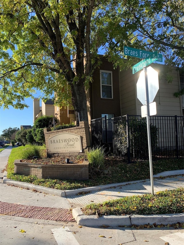 community sign featuring fence