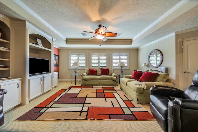 living room with a tray ceiling, ornamental molding, a textured ceiling, and light colored carpet