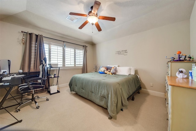 carpeted bedroom with visible vents, a ceiling fan, vaulted ceiling, a textured ceiling, and baseboards