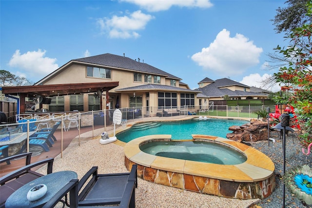 view of pool featuring a sunroom, a fenced backyard, a pool with connected hot tub, and a patio