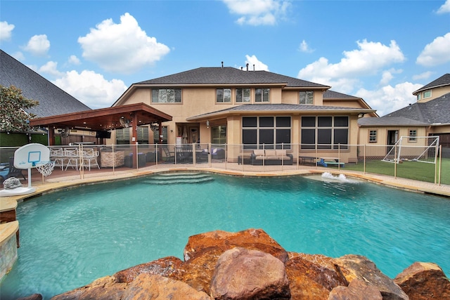 view of swimming pool with a fenced in pool, a sunroom, a patio area, and fence