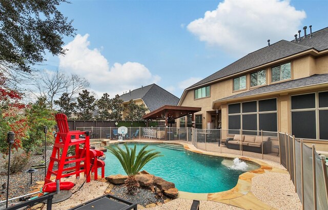 view of swimming pool featuring a patio area, fence, and a pool with connected hot tub