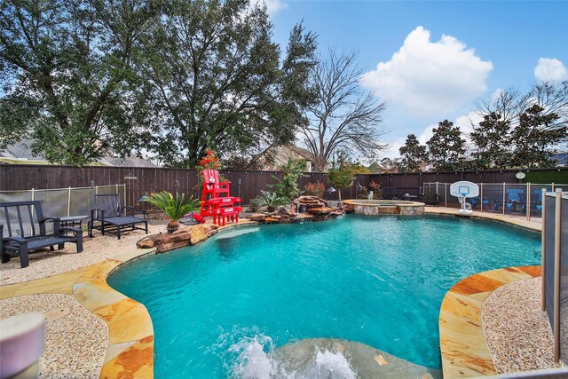 view of pool with a patio area, a fenced backyard, and a pool with connected hot tub