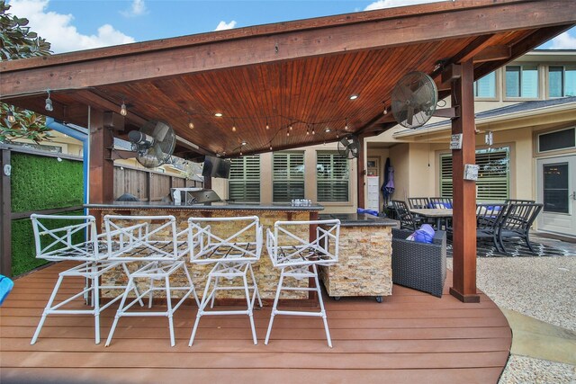 deck with area for grilling and outdoor wet bar