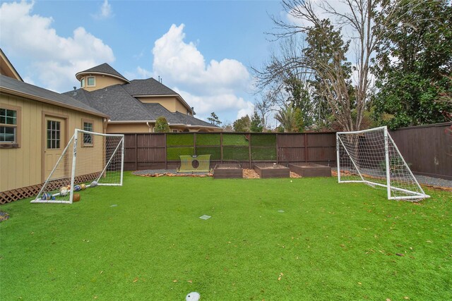 view of yard with a vegetable garden and fence