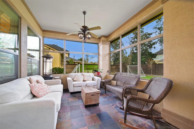 sunroom with a wealth of natural light and ceiling fan