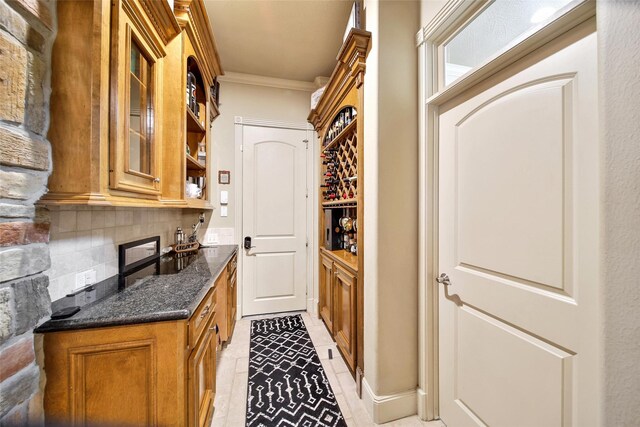 interior space featuring light tile patterned floors, ornamental molding, and backsplash