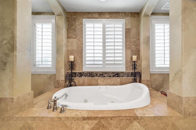 full bath with visible vents and a tub with jets