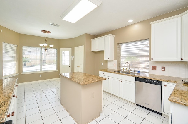 kitchen with decorative backsplash, a center island, a sink, and stainless steel dishwasher