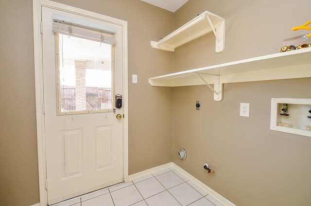 clothes washing area featuring laundry area, gas dryer hookup, hookup for a washing machine, hookup for an electric dryer, and light tile patterned flooring