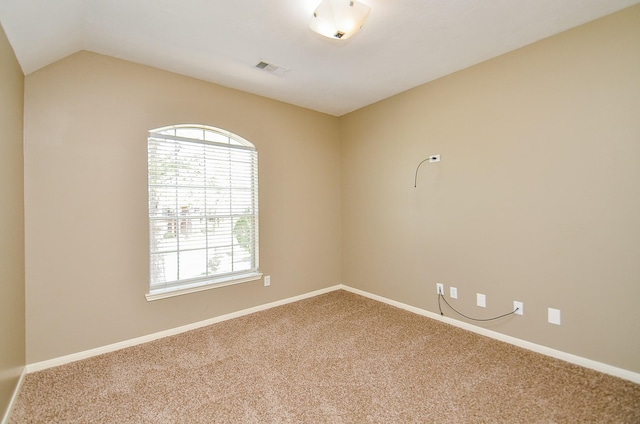 unfurnished room featuring lofted ceiling, carpet floors, visible vents, and baseboards