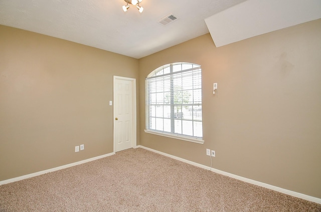 unfurnished room with carpet flooring, visible vents, and baseboards