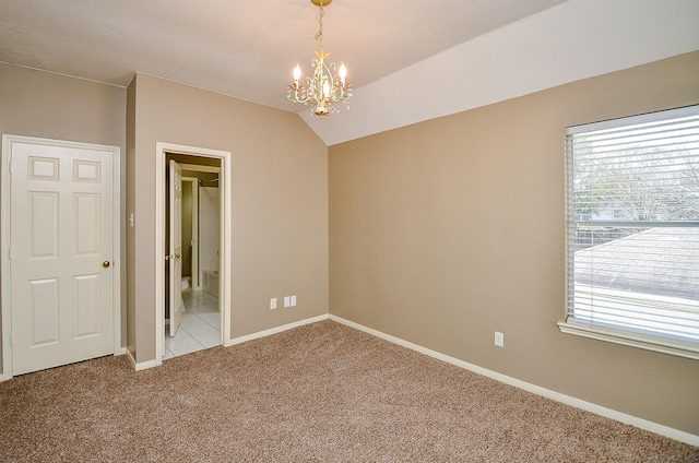 unfurnished room featuring light carpet, baseboards, lofted ceiling, and a healthy amount of sunlight