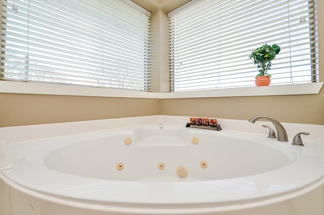 bathroom with a tub with jets