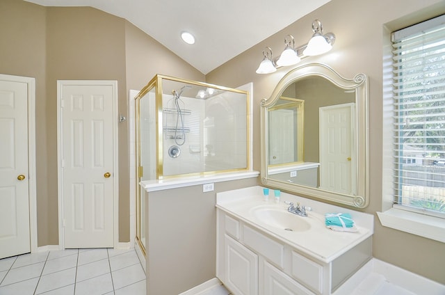 bathroom featuring lofted ceiling, a stall shower, vanity, and tile patterned floors