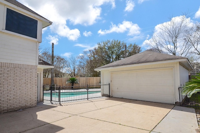 view of swimming pool featuring a patio area, fence, a fenced in pool, and an outdoor structure