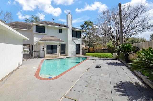 view of swimming pool with a fenced backyard, a fenced in pool, and a patio