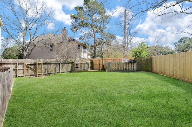 view of yard with a fenced backyard