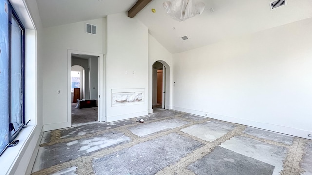 empty room featuring high vaulted ceiling, visible vents, arched walkways, and beam ceiling