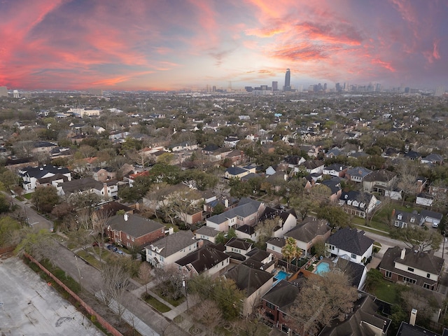 aerial view at dusk featuring a residential view