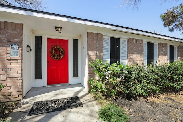 property entrance with brick siding