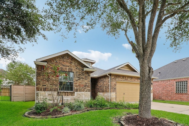 ranch-style home with driveway, stone siding, an attached garage, fence, and a front lawn