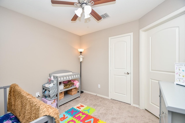 bedroom featuring light carpet, visible vents, ceiling fan, and baseboards