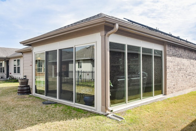 view of side of home featuring a lawn