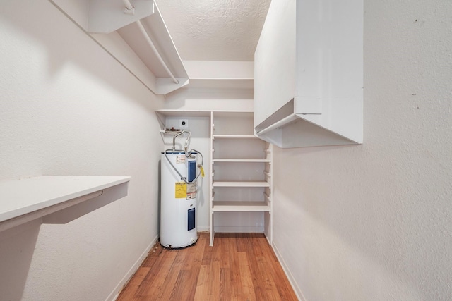 utility room with electric water heater