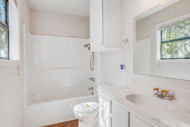 bathroom featuring shower / bathtub combination, wood finished floors, vanity, and toilet