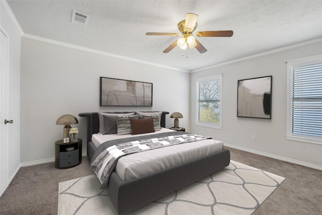 bedroom with carpet, visible vents, crown molding, and baseboards