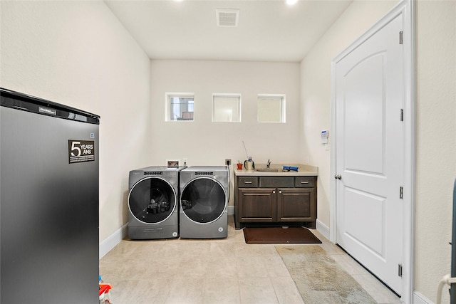 26407 Katy Springs Ln, Katy, TX 77494 - clothes washing area with washing machine and dryer, a sink, visible vents, baseboards, and cabinet space