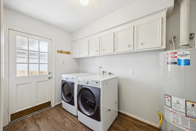 laundry room with dark wood-style flooring, water heater, cabinet space, and washer and clothes dryer