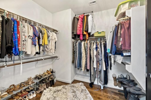 walk in closet with wood finished floors and visible vents