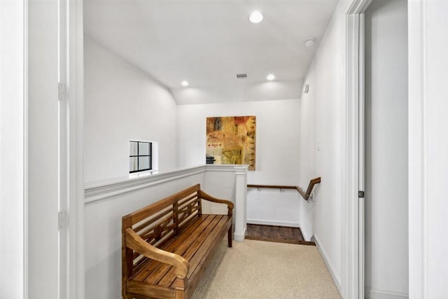 hall with recessed lighting, visible vents, carpet flooring, vaulted ceiling, and baseboards