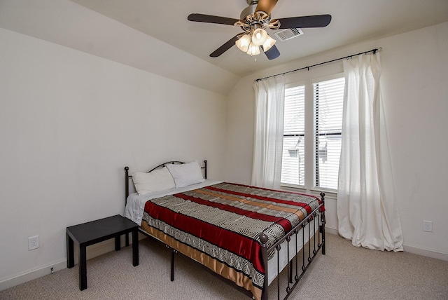 bedroom featuring baseboards, visible vents, vaulted ceiling, and light colored carpet