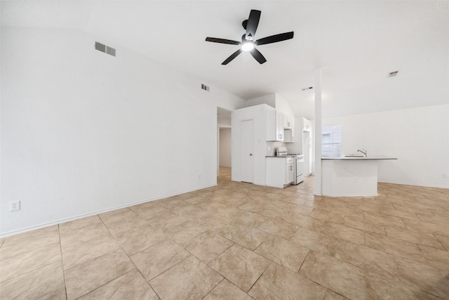 unfurnished living room with vaulted ceiling, a sink, visible vents, and a ceiling fan