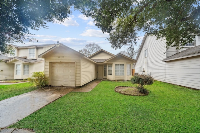 view of front of property featuring driveway, an attached garage, and a front yard